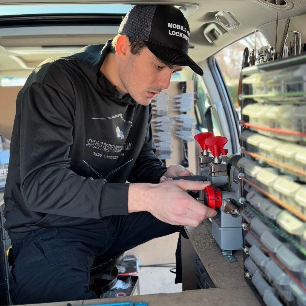 Technician working inside a van, adjusting equipment mounted on the side panel.