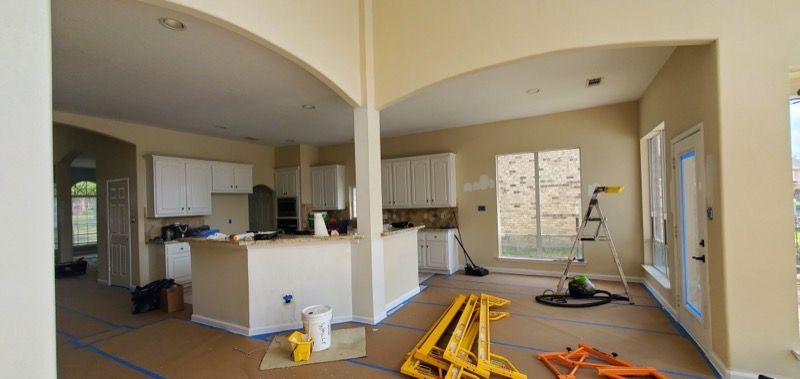 A kitchen and living room in a house under construction.