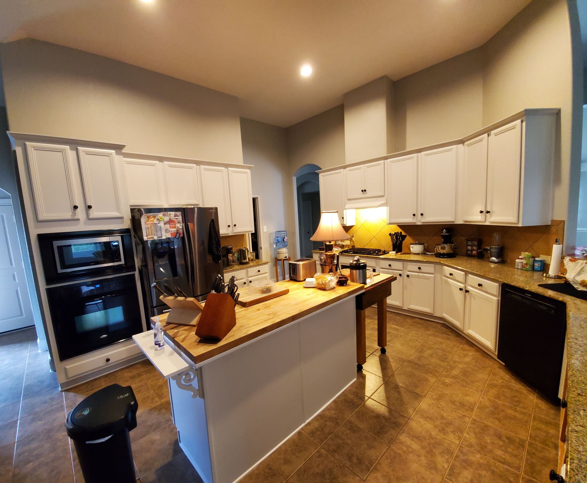 A kitchen with white cabinets and green walls is being remodeled.