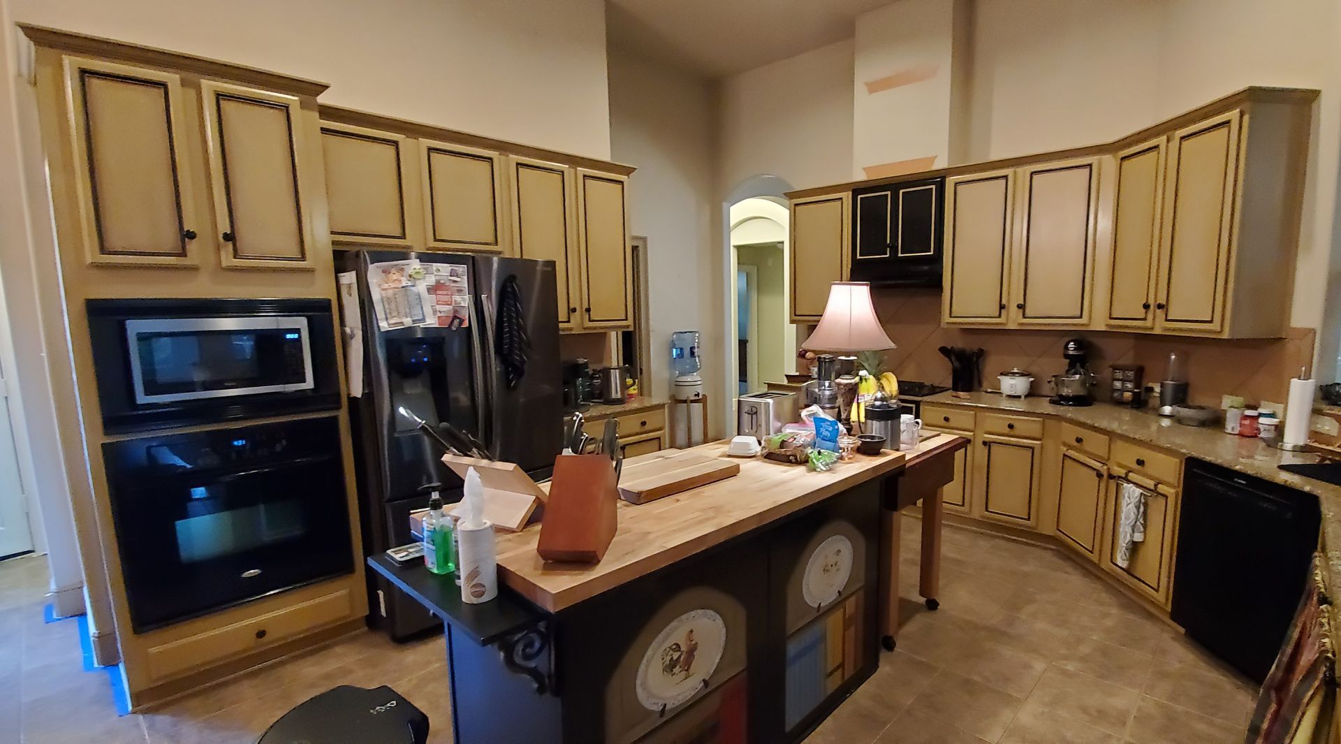 A kitchen with green walls and stainless steel appliances.