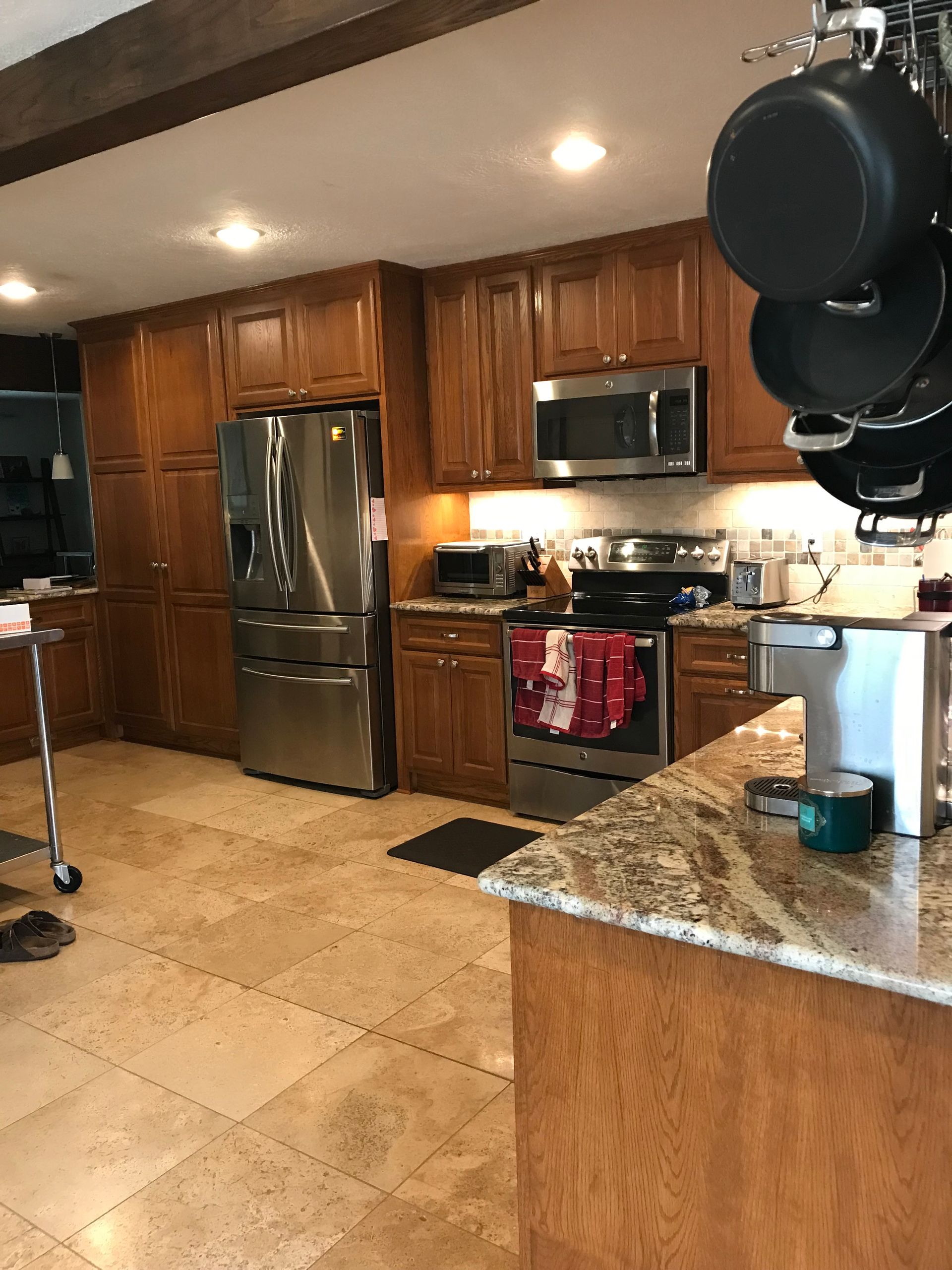 A kitchen with green walls and stainless steel appliances.