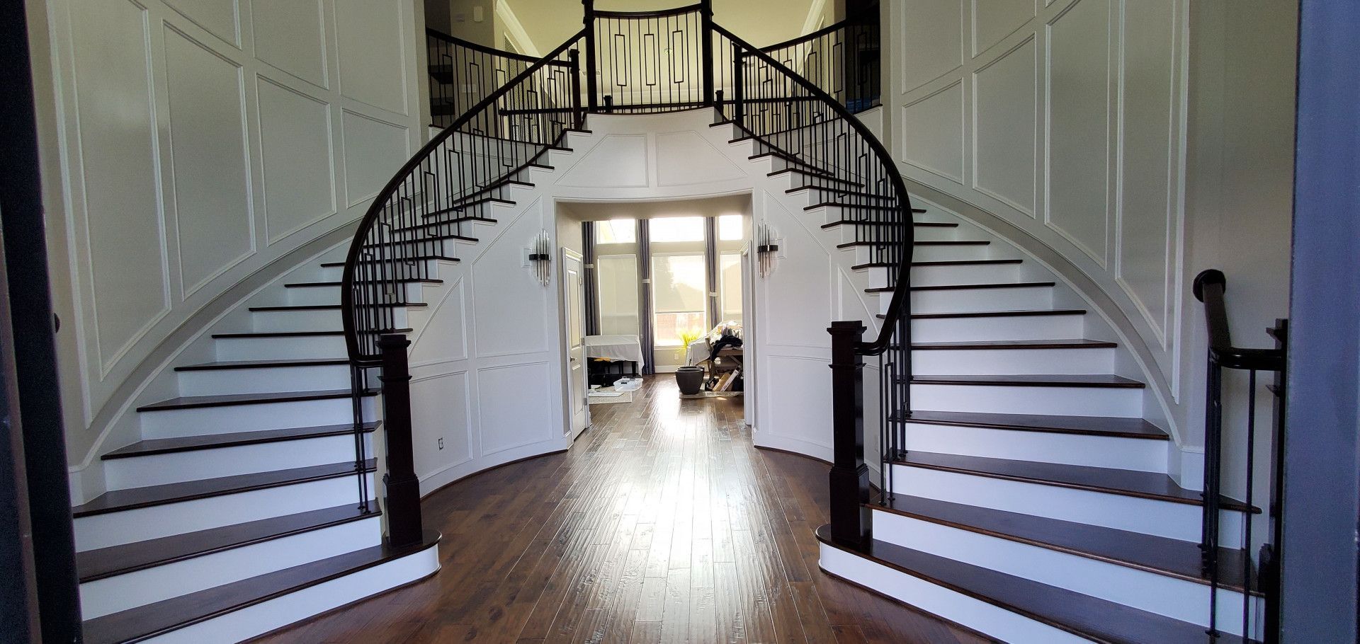 There is a large staircase in the middle of the hallway.