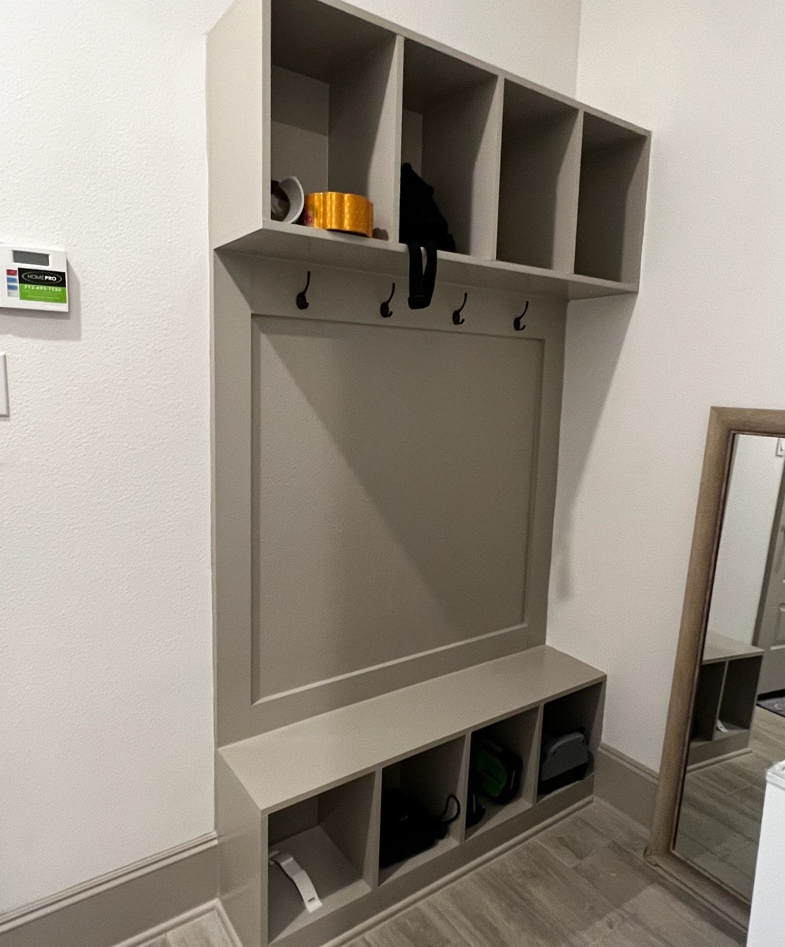 A hallway with a coat rack and a mirror