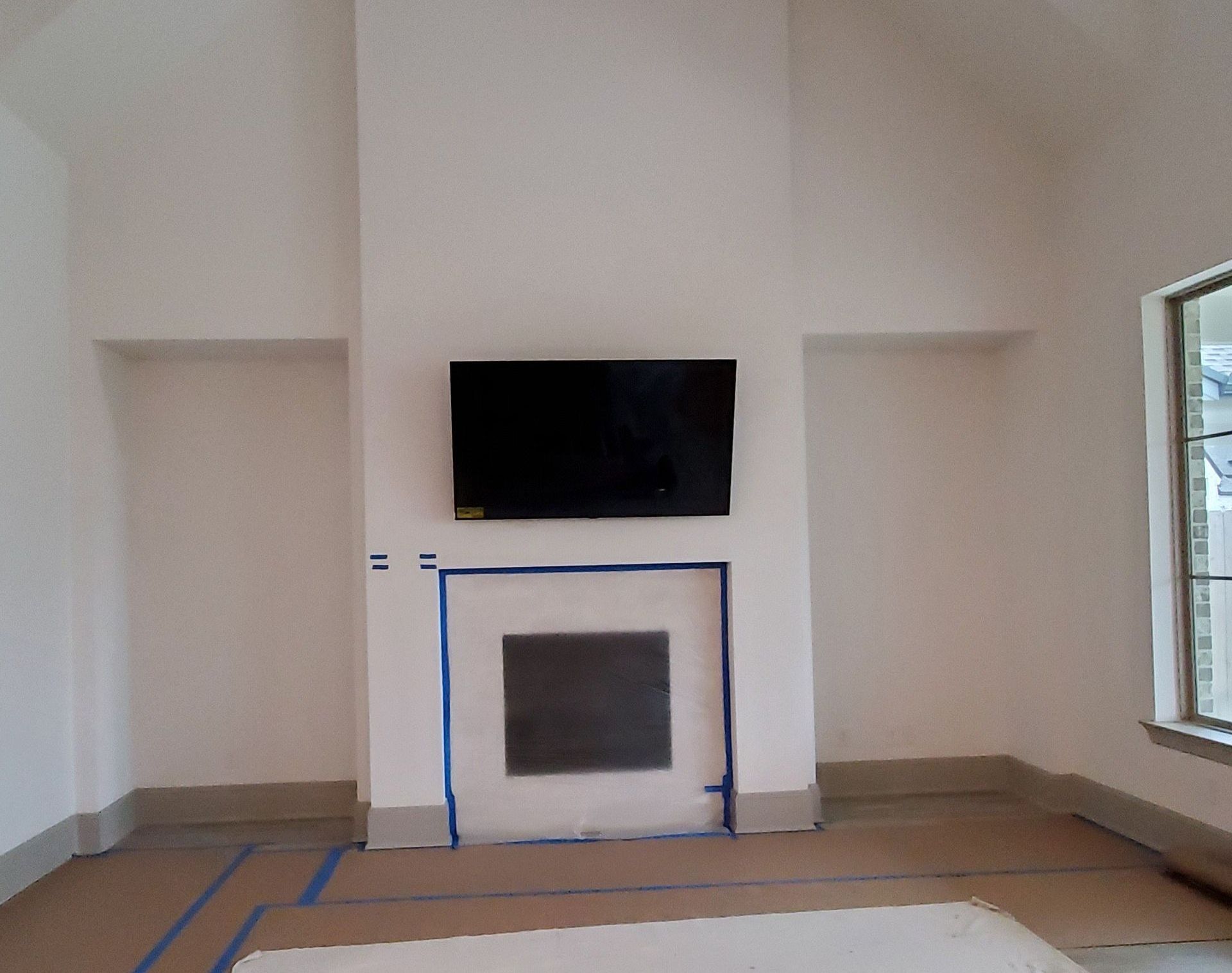 A living room with a fireplace and a flat screen tv