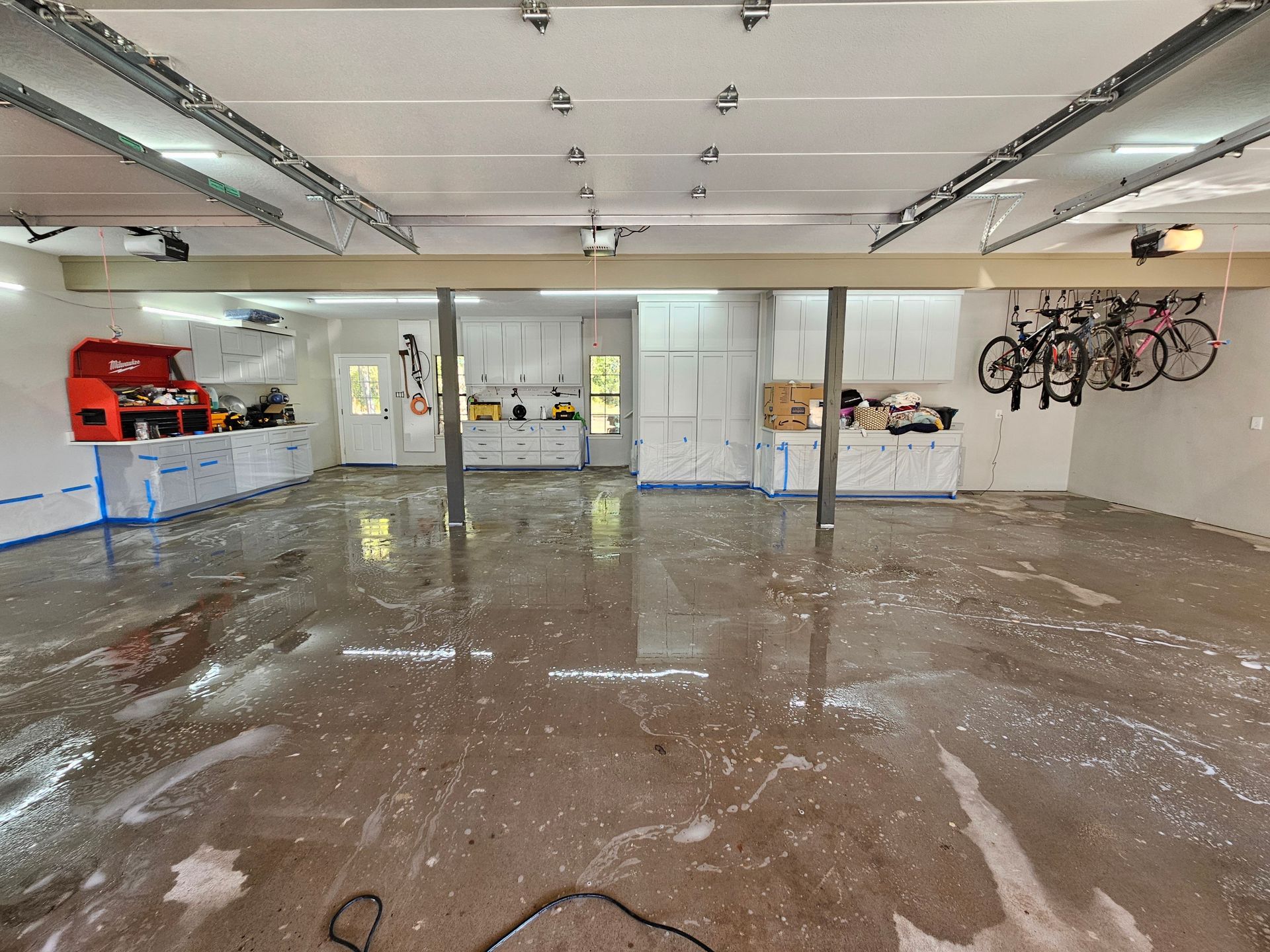 A flooded garage with bikes hanging from the ceiling