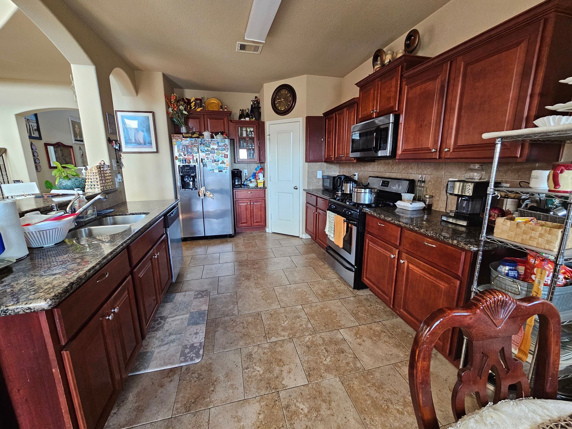 A kitchen with wooden cabinets and granite counter tops