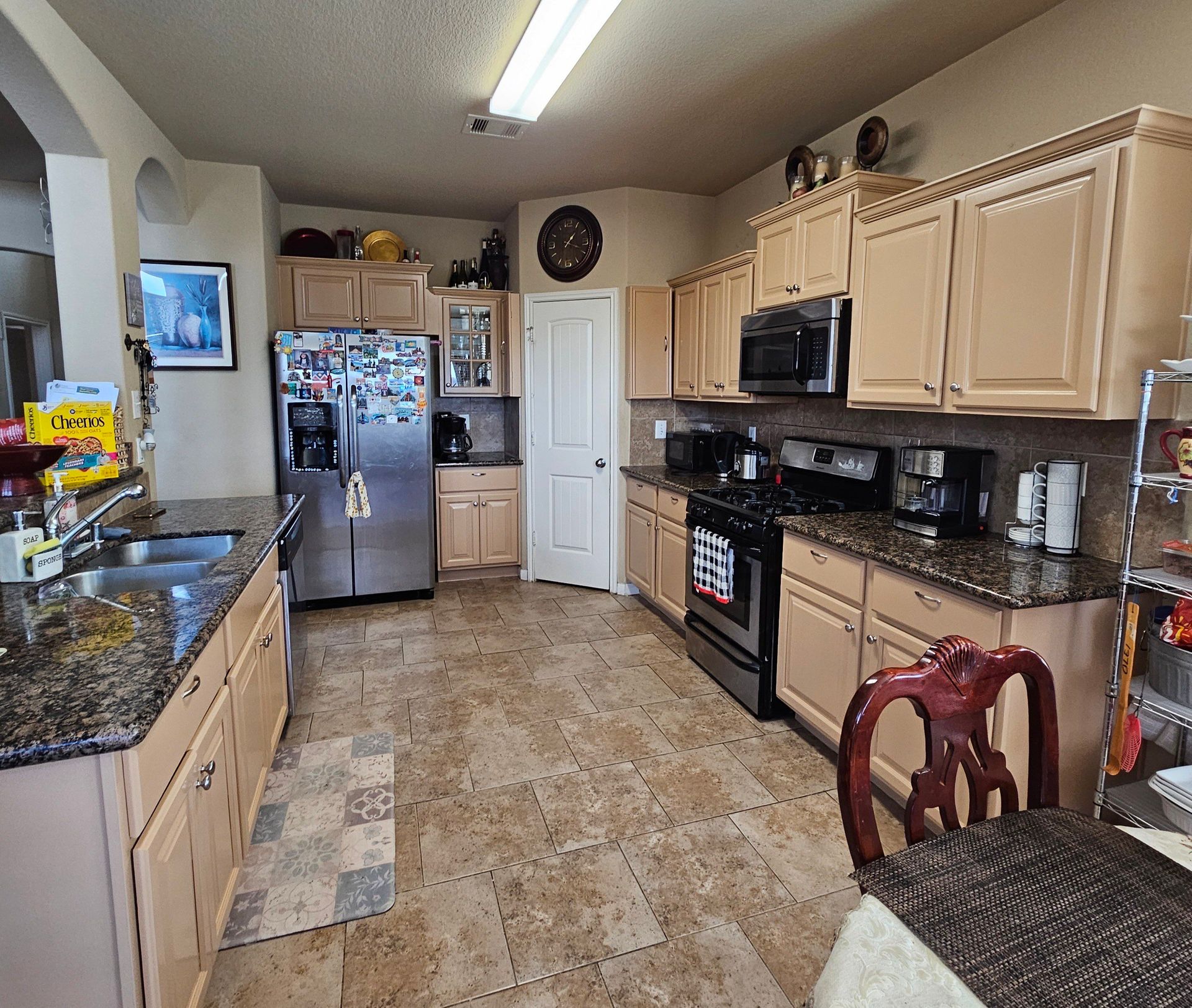 A kitchen with stainless steel appliances and granite counter tops