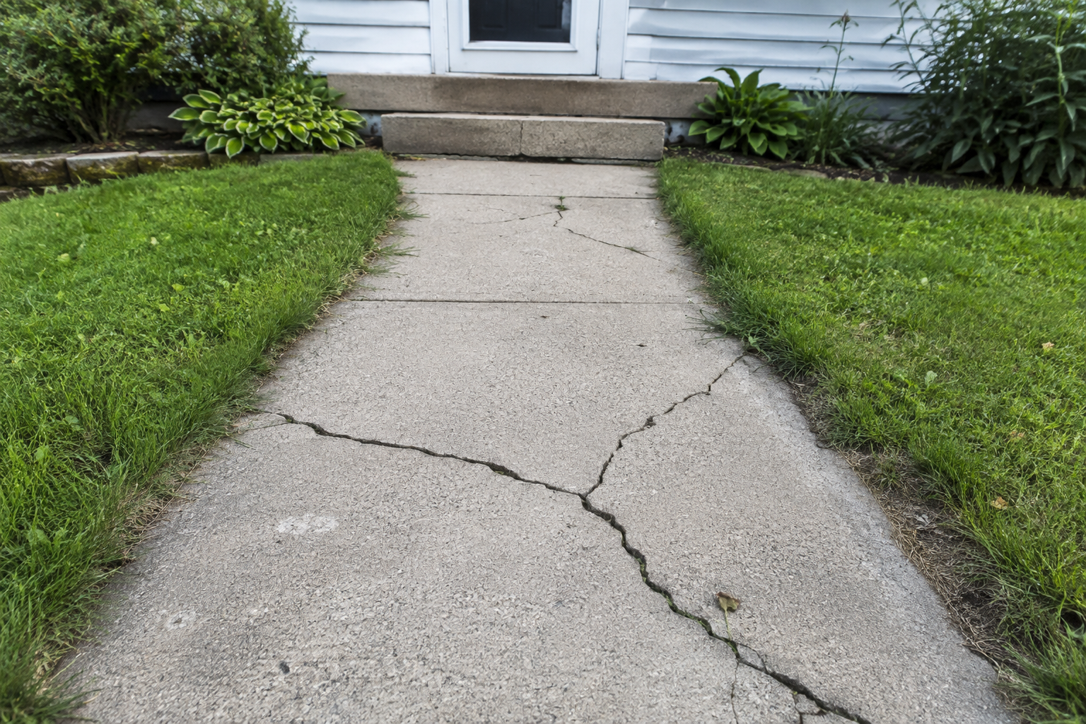 An image of a cracked concrete walkway in Bristol, CT