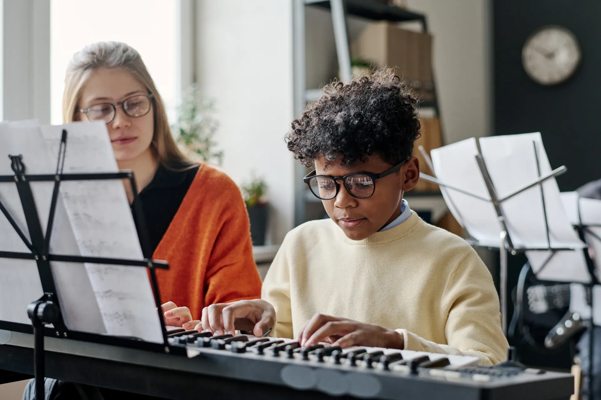 Child practicing piano at home as part of a music enrichment program in Manatee County