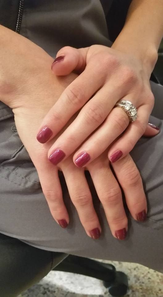 A close up of a woman 's hands with a ring on her finger