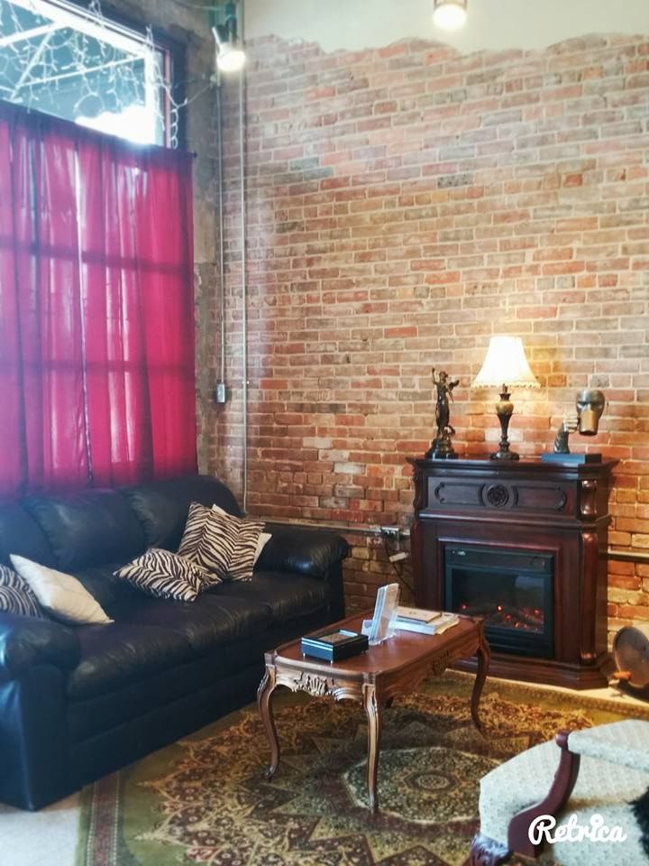A living room with a fireplace and a couch