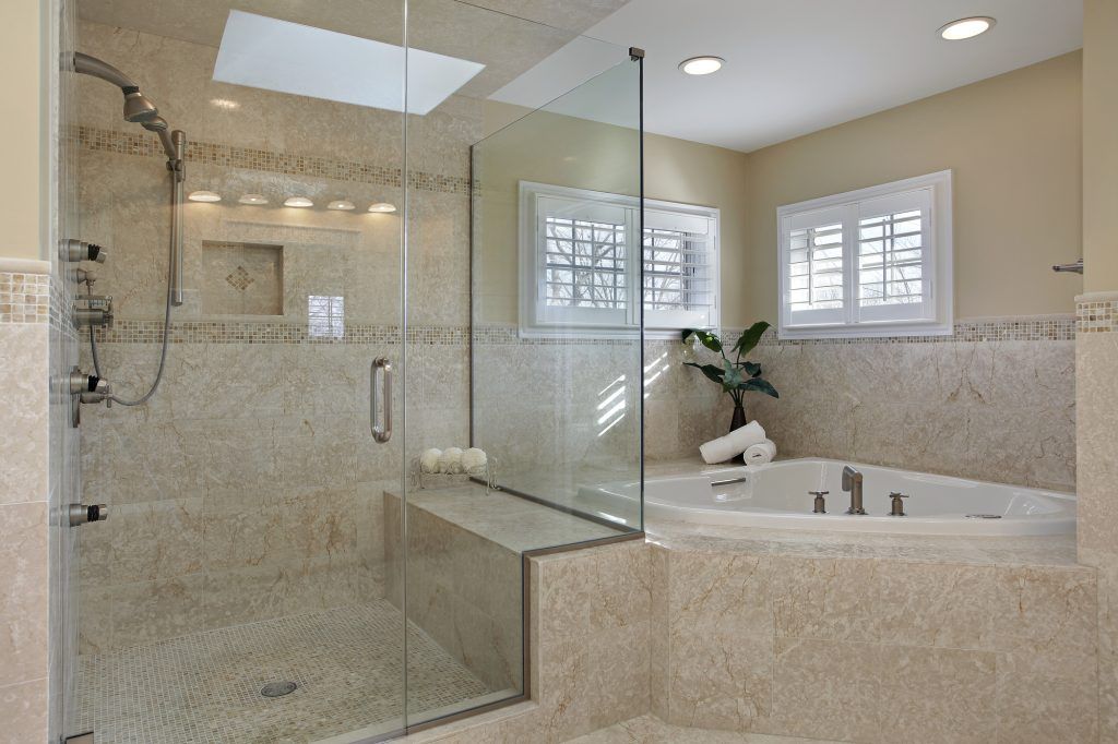 a bathroom with a walk in shower and shower made by and installed by Sun Glass