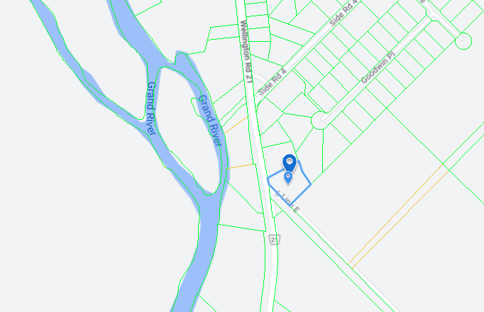 Map with blue location pin beside a river and road network