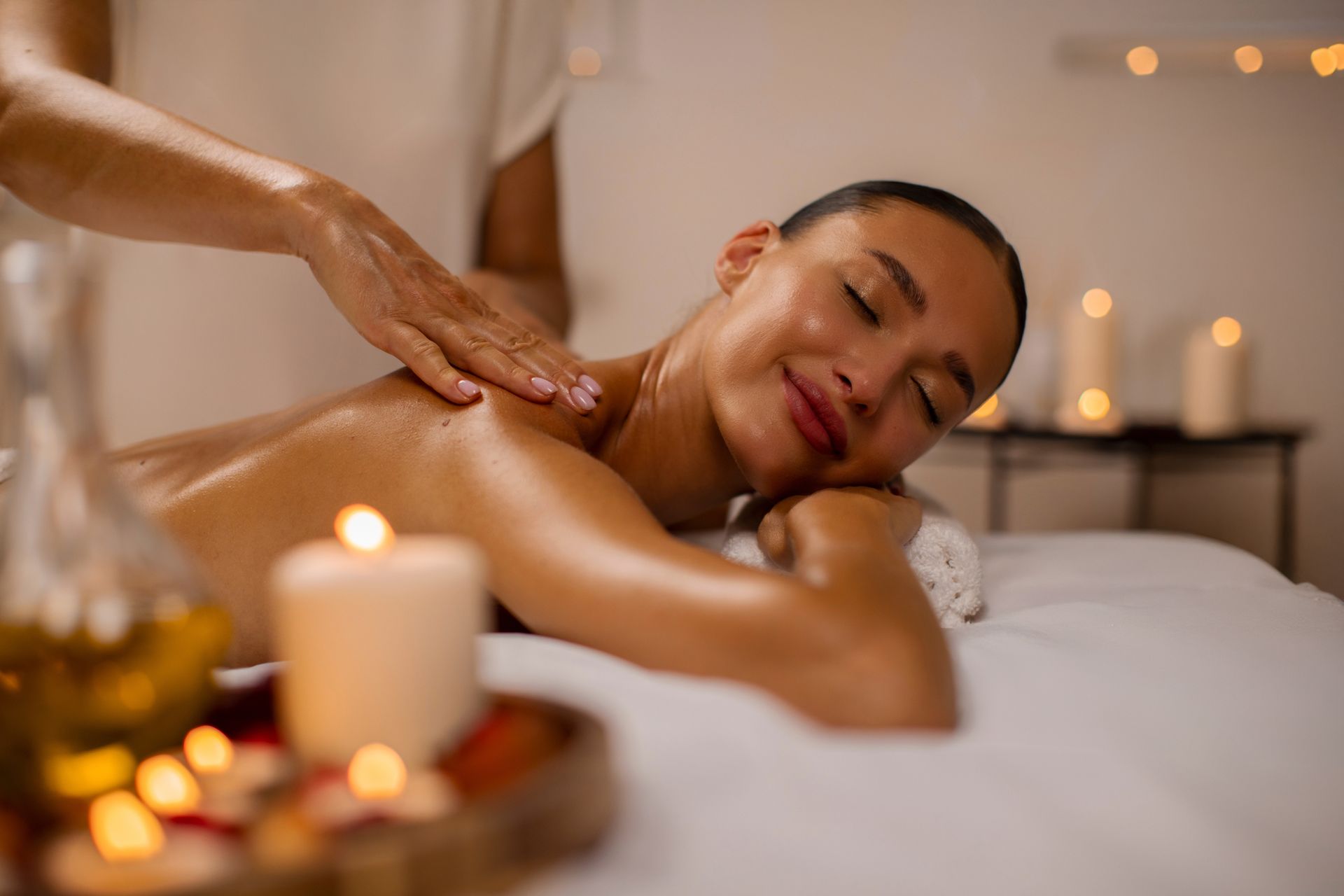 Shoulder massage in a warm softly lit treatment room