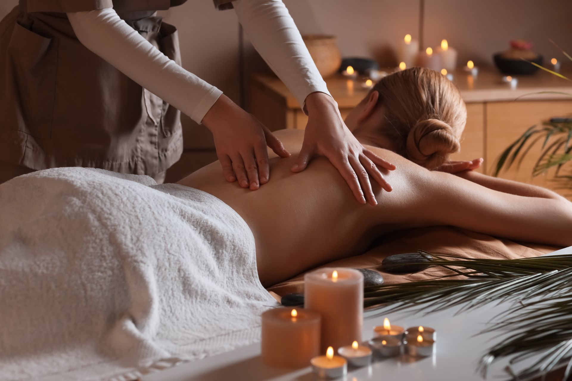 Warm candlelit spa room during a massage session at New Move Massage Pittsfield MA