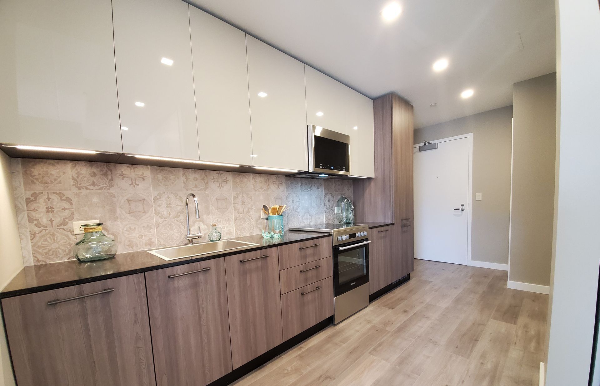 A kitchen with wooden cabinets and stainless steel appliances