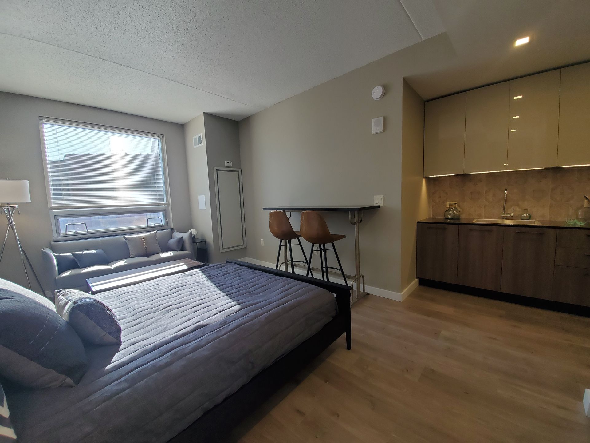 A bedroom with a bed and a couch in it