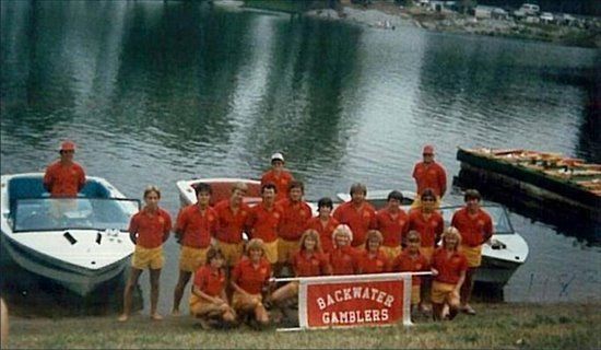A group of people posing for a picture with a sign that says Backwater Gamblers