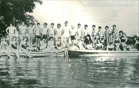 A group of people are posing for a picture in the water.