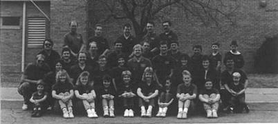 A black and white photo of the ski team posing for a picture