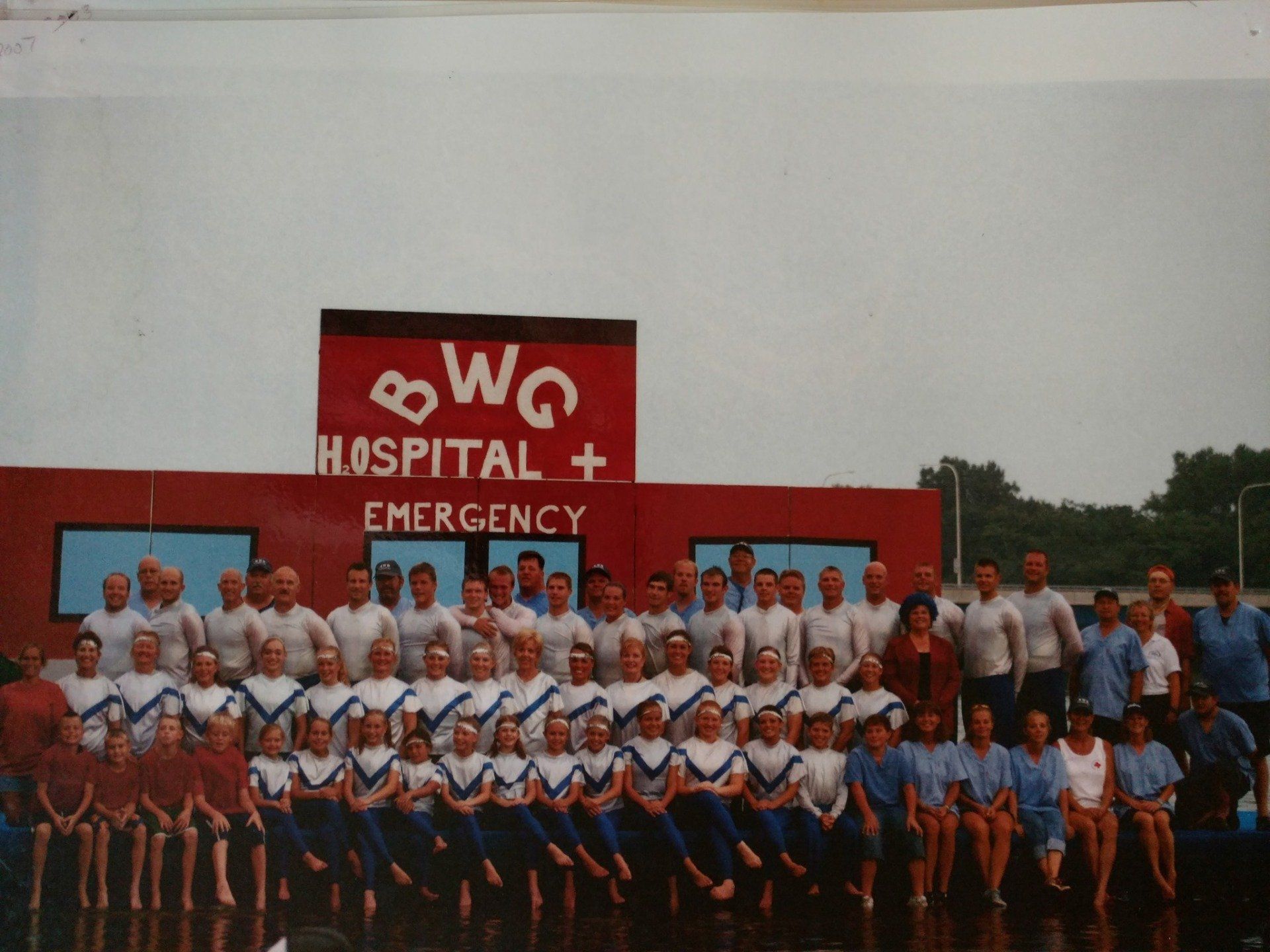 A group of people standing in front of a hospital sign