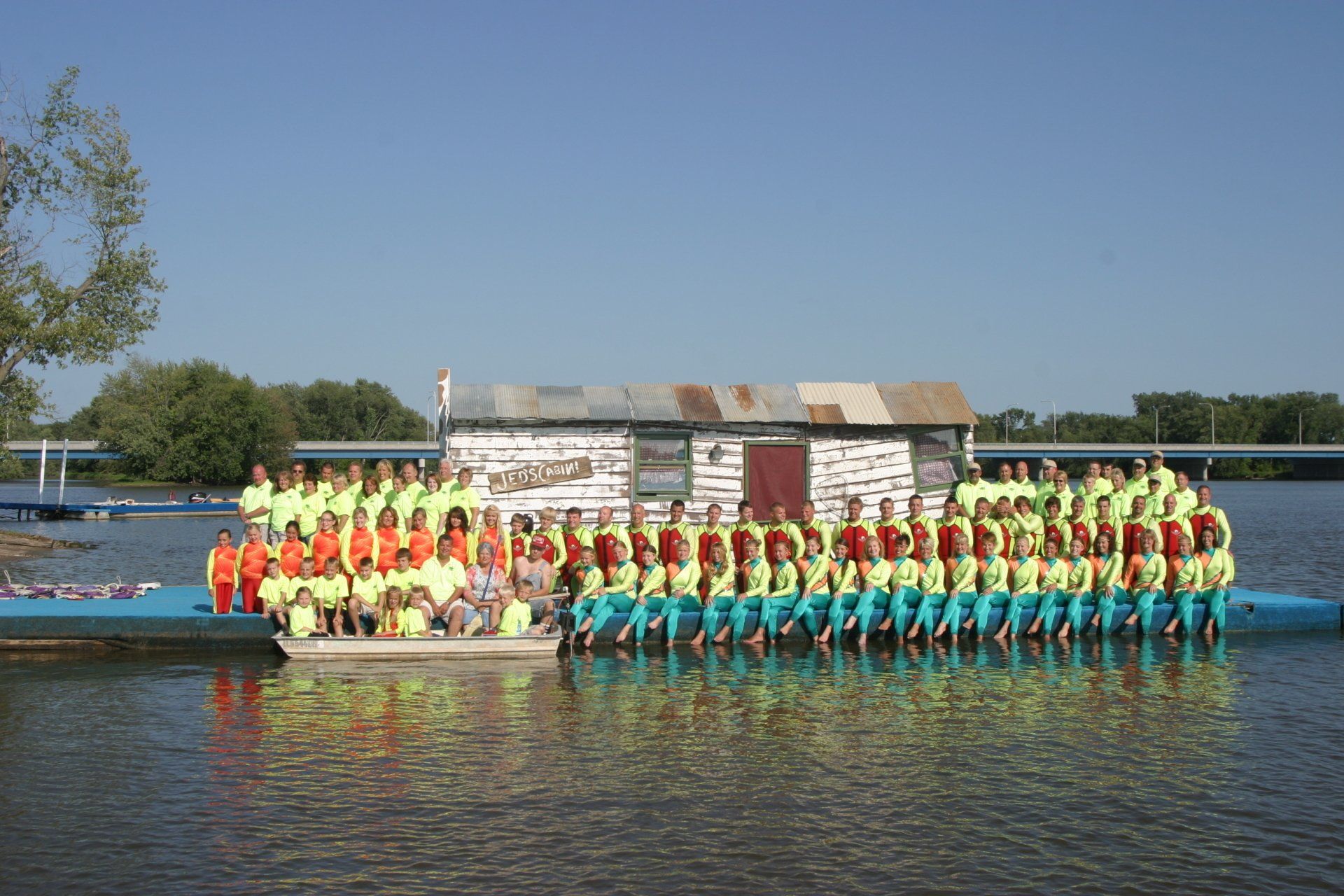 A group of people are posing for a picture on a dock