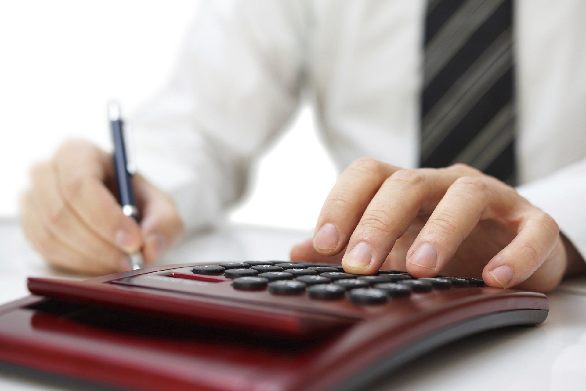 Holding a Pen and Calculator — Melville, NY — All Access Financial Holding a Pen and Calculator — Melville, NY — All Access Financial