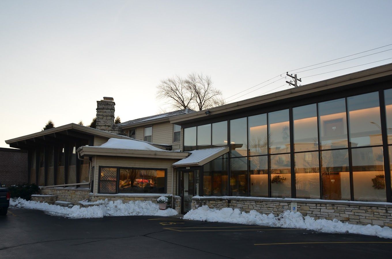 A large building with a lot of windows is covered in snow.