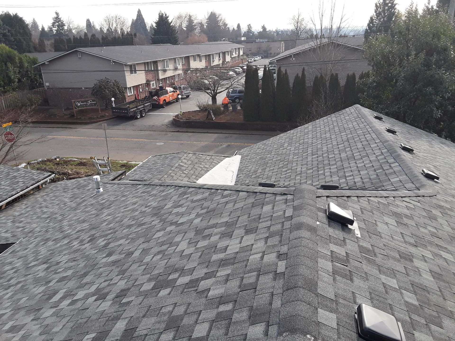 an aerial view of a roof with a building in the background .