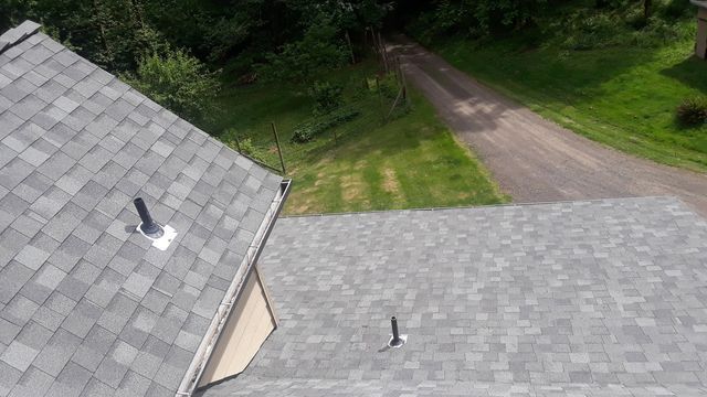 an aerial view of a roof with a driveway in the background .