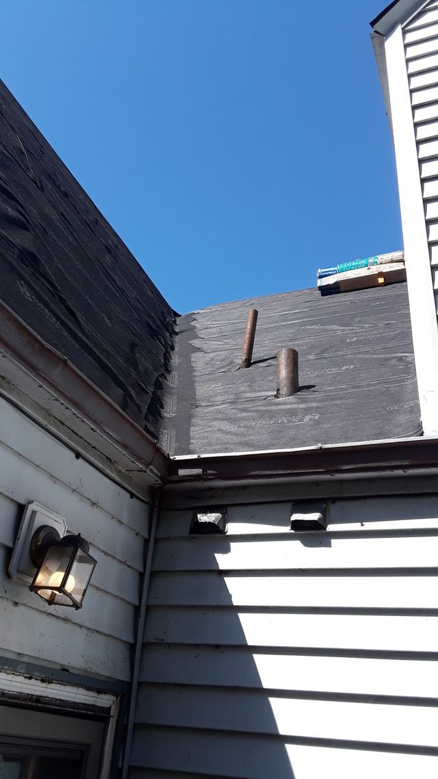 a roof of a house with a blue sky in the background