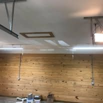 A garage with a wooden wall and ceiling.