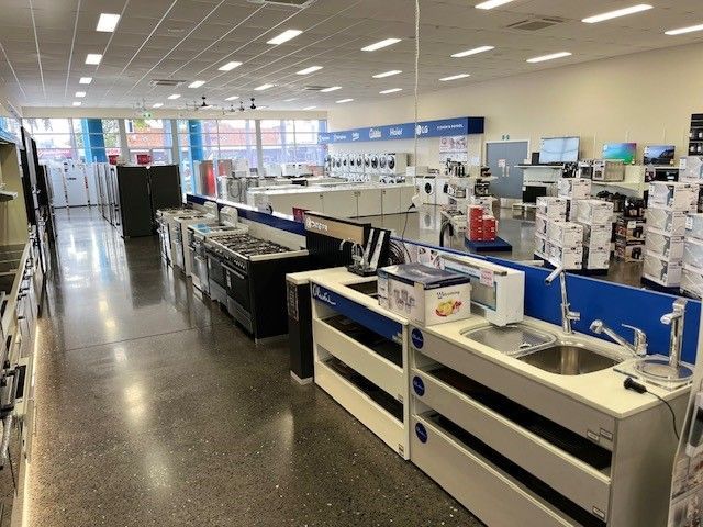A Woman is Advertising a Washing Machine — The Latest Home Appliances in Rockhampton