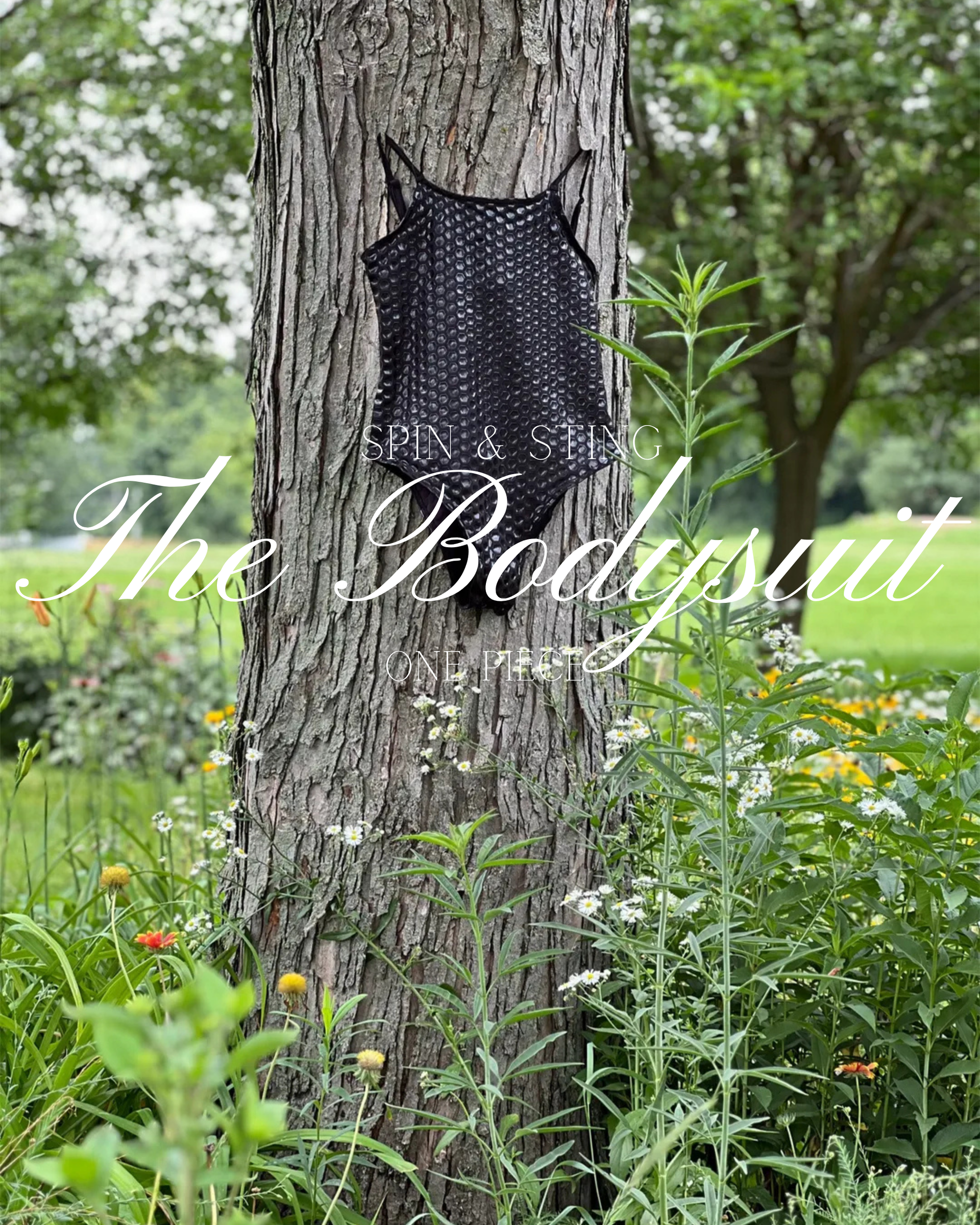 Black bodysuit on a tree trunk in a green garden with flowers and cursive text overlay Sticky Grippy Pole-wear