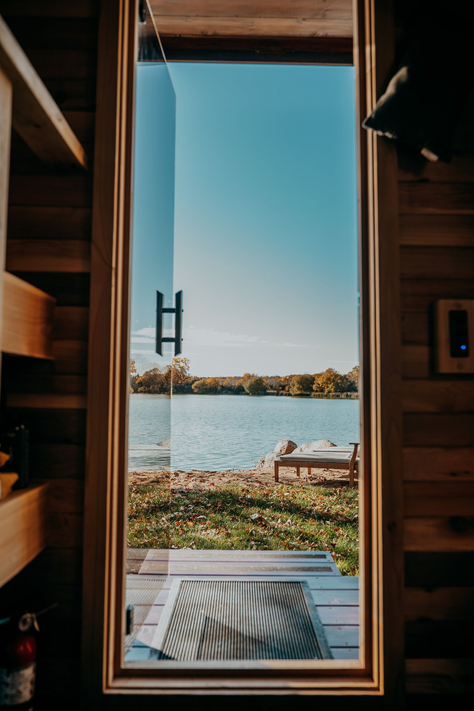 A view of a lake through a window in a house.