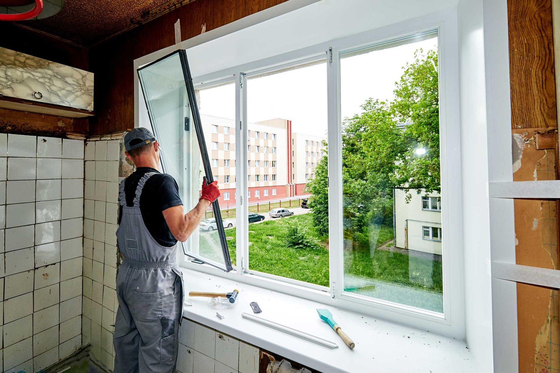 A man is installing a window.