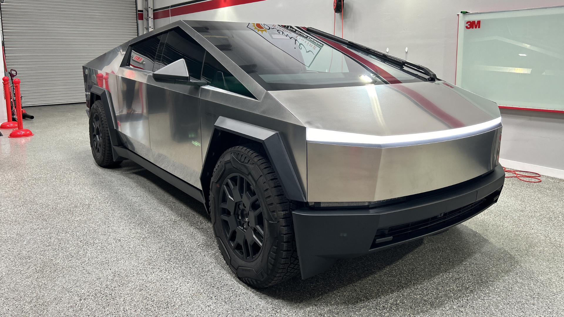 A tesla cybertruck is parked in a garage.