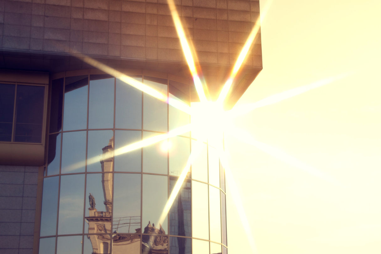 The sun shining through the windows of a building protected with security film.