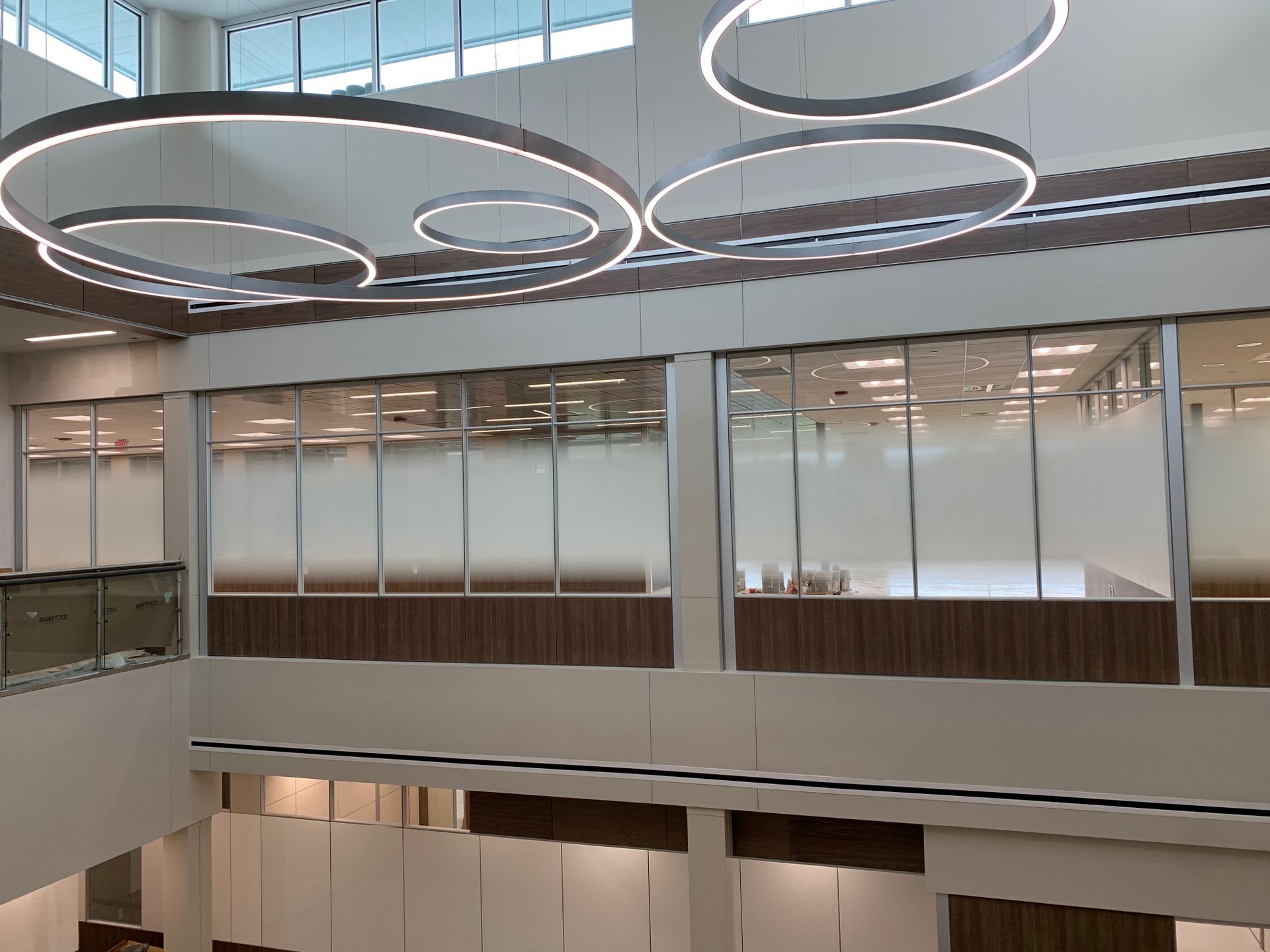 A large building with a lot of windows and lights hanging from the ceiling