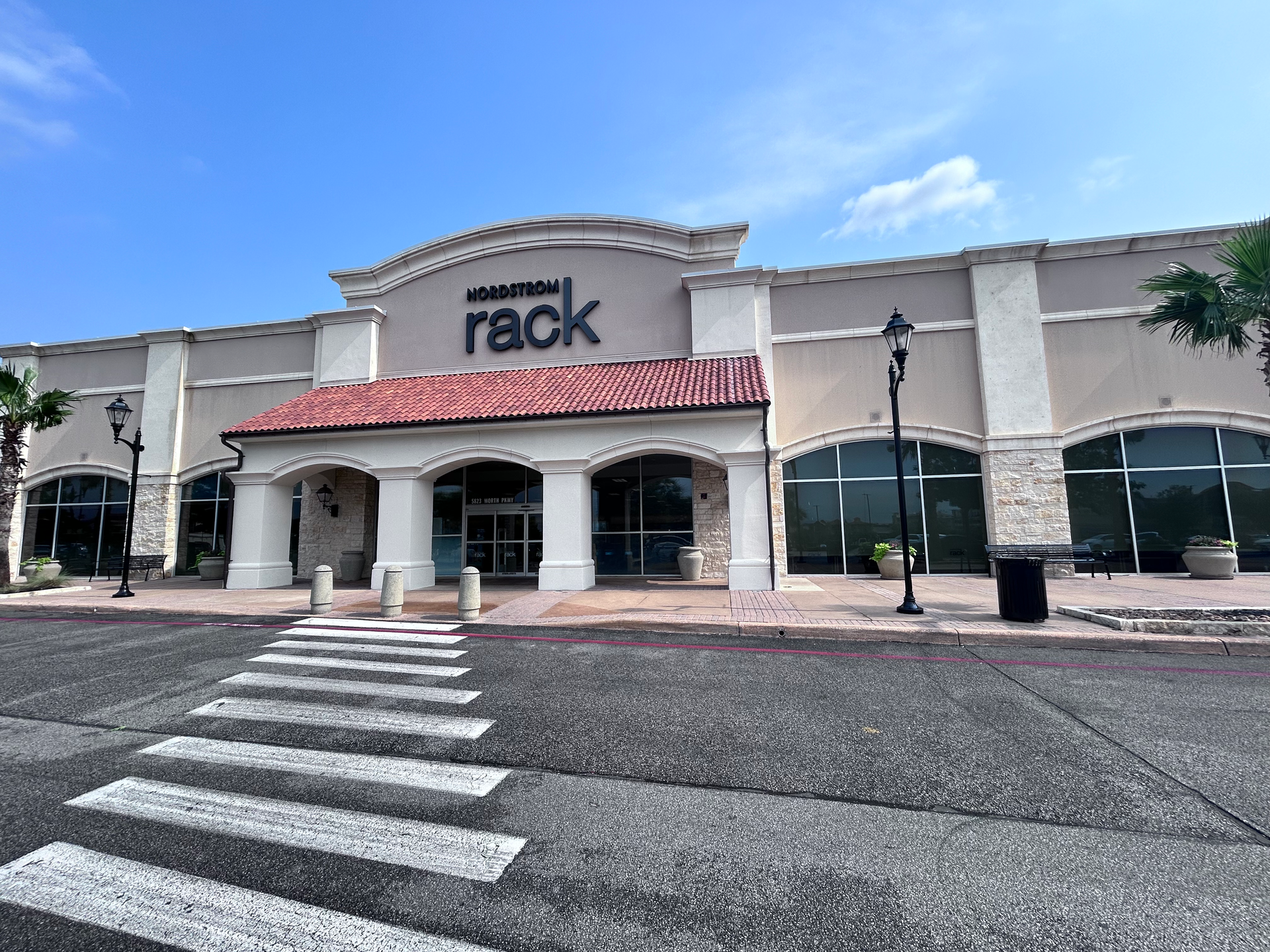 A rack store with a crosswalk in front of it