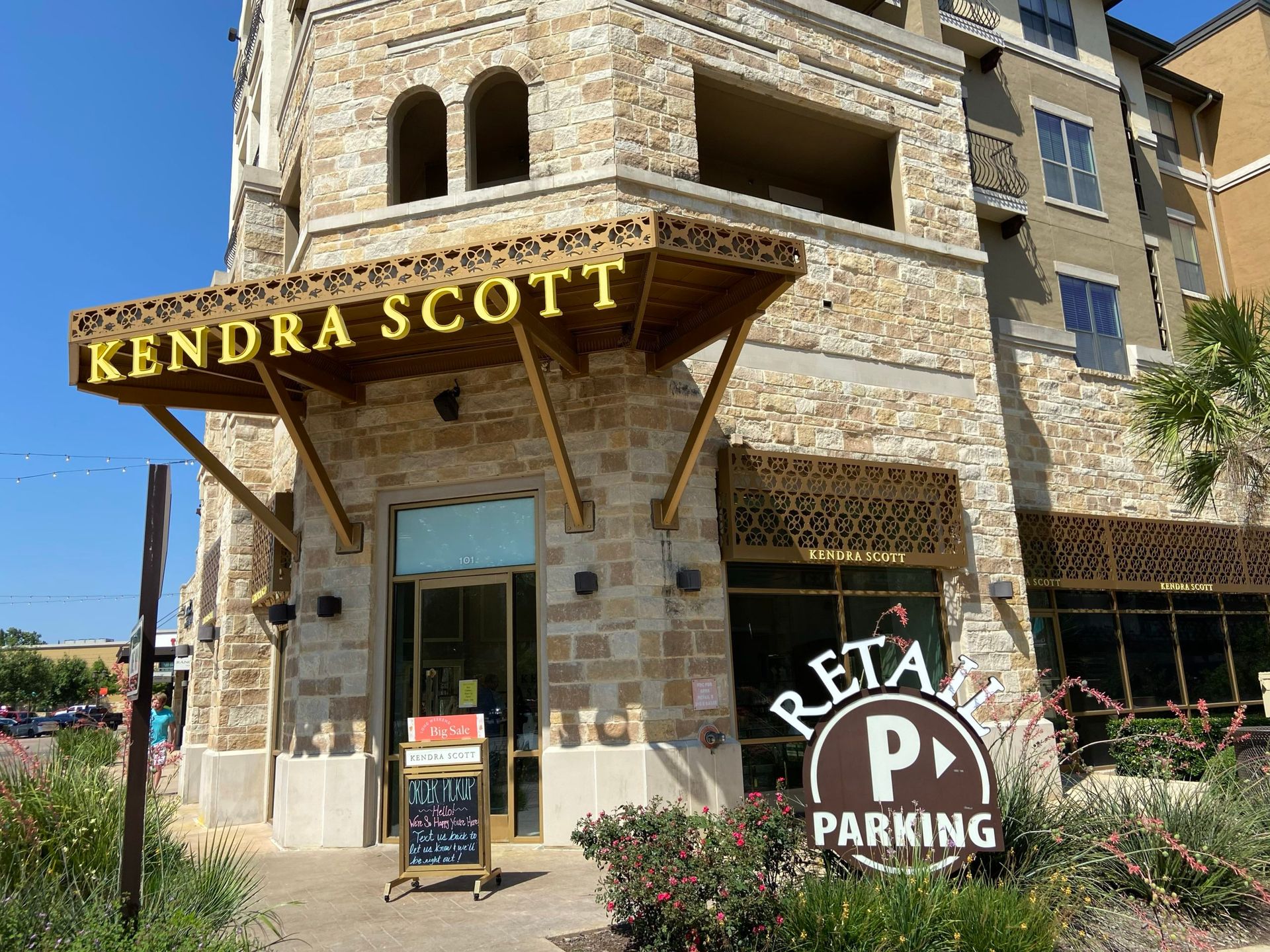 A large stone building with a sign that says kendra scott