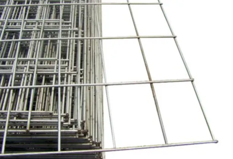 A stack of rectangular galvanized steel wire fencing mesh panels, with one panel extending to the right.