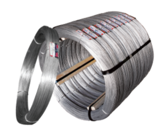 A large spool of silver industrial wire coils alongside a single detached ring of the same metallic wire.