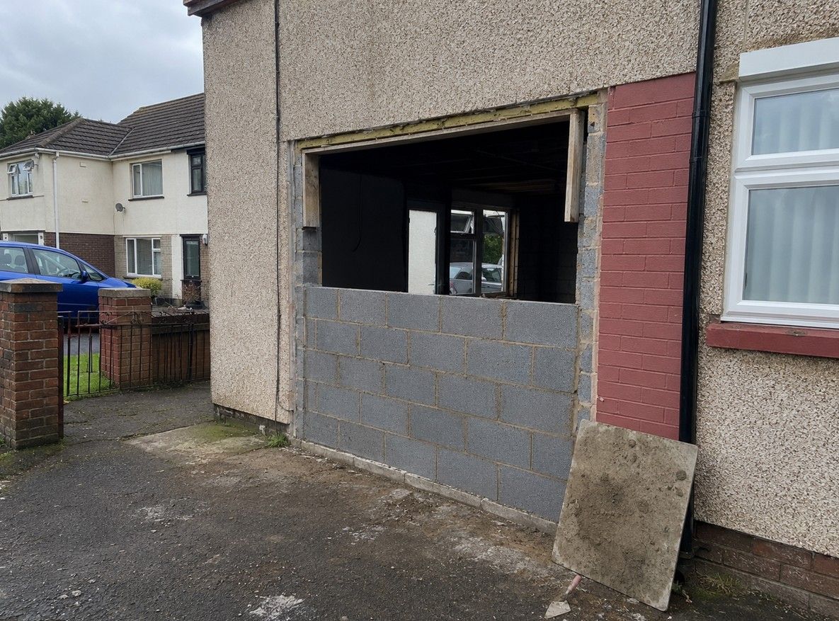 J&Z Property Maintenance infilling a garage door opening with blockwork at a Cardiff property