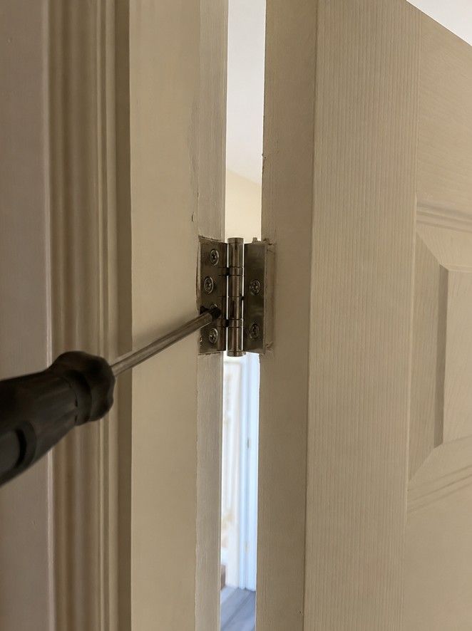 J&Z Property Maintenance handyman repairing a door at a Cardiff property