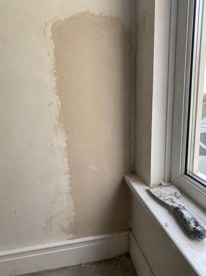 J&Z Property Maintenance handyman repairing a drywall hole in a Cardiff property