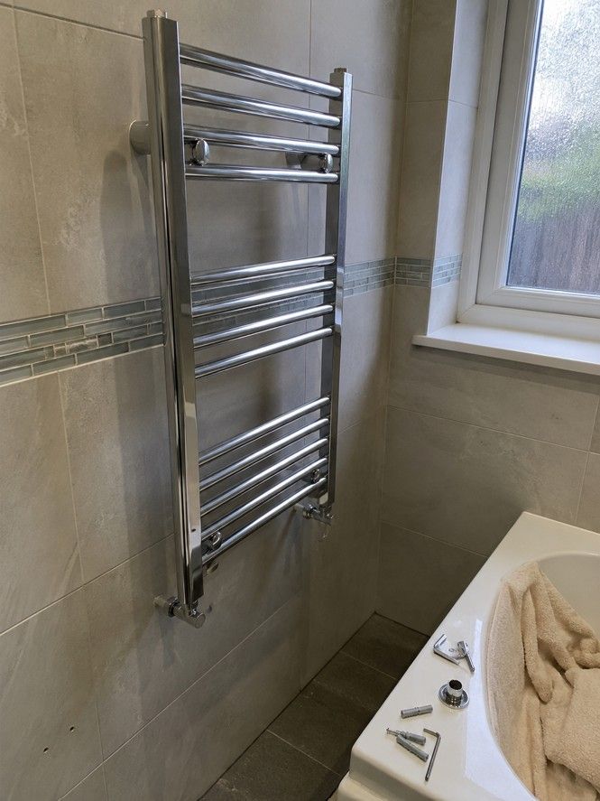 J&Z Property Maintenance handyman fitting a bathroom accessory in Cardiff
