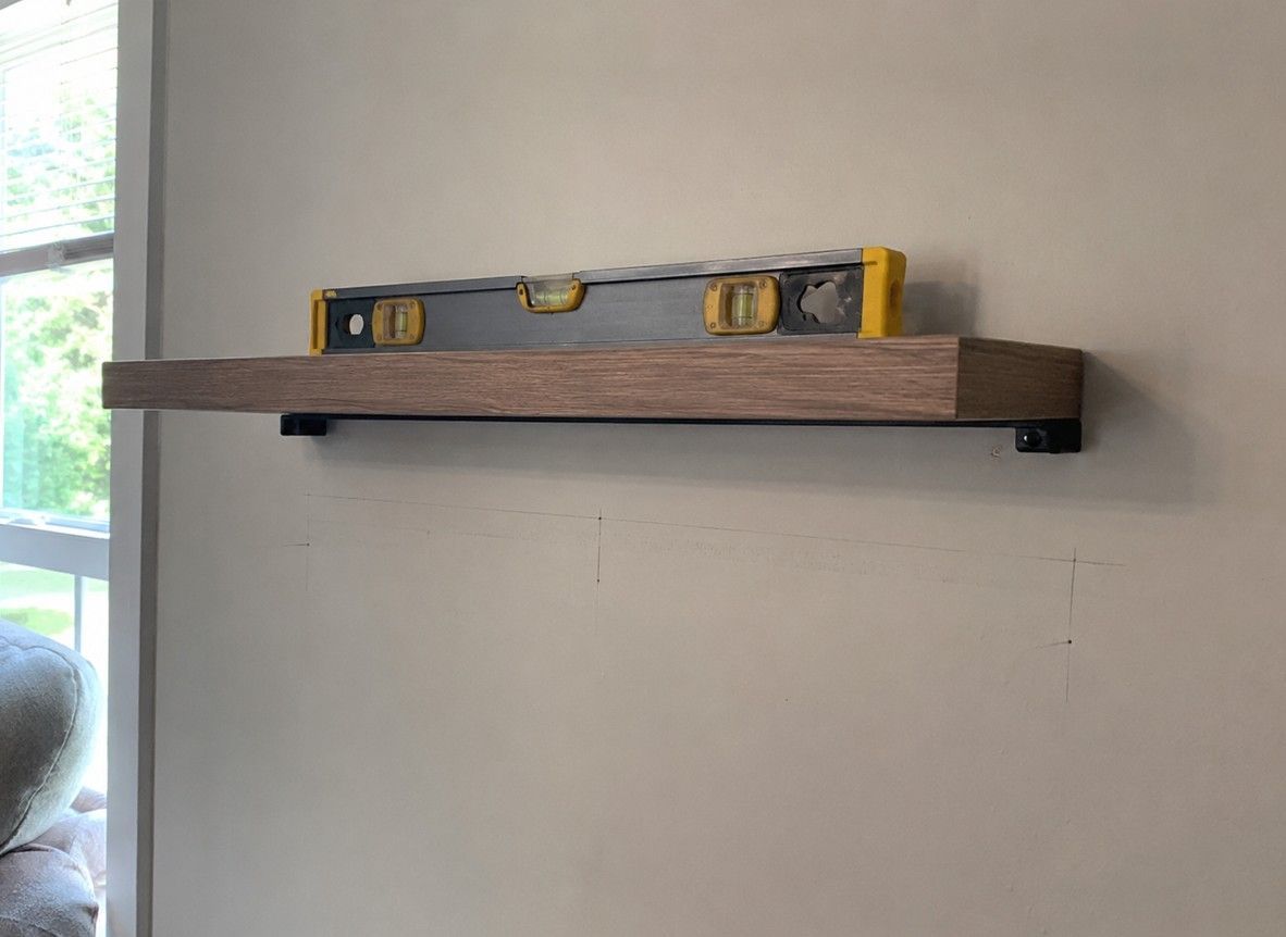 J&Z Property Maintenance handyman fitting shelves in a Cardiff home