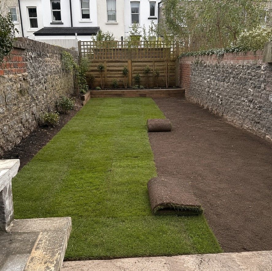 J&Z Property Maintenance laying new turf in a Cardiff garden