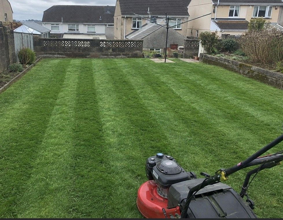J&Z Property Maintenance mowing a lawn at a residential property in Barry